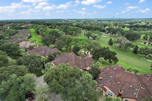an aerial view of a house with a yard and lake view