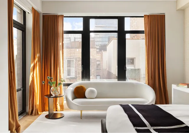 a spacious bedroom with a bed and a large window