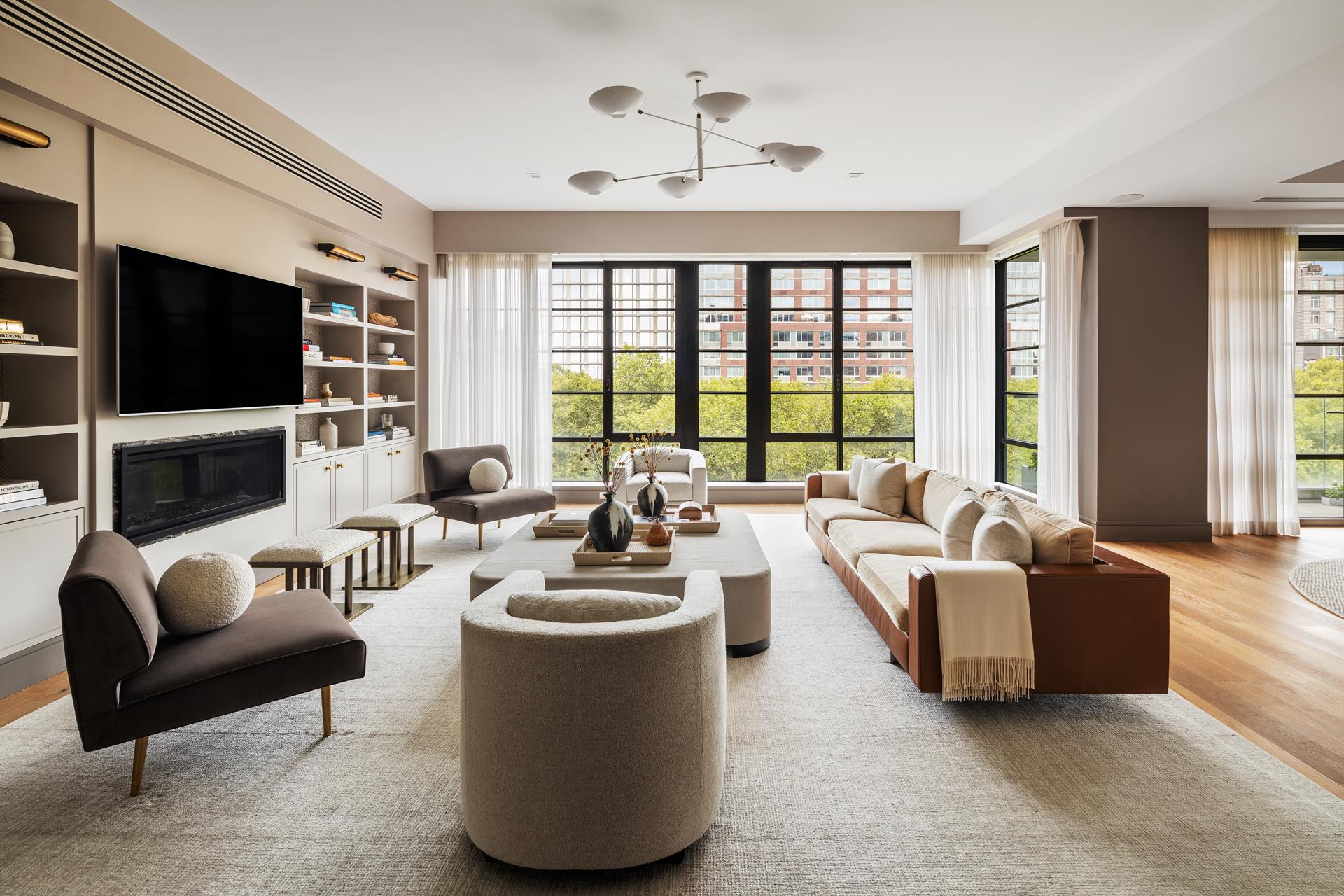 204 Forsyth Street, Unit PH6 Manhattan, NY 10002 - Photo 2 of 22 a living room with fireplace furniture and a flat screen tv