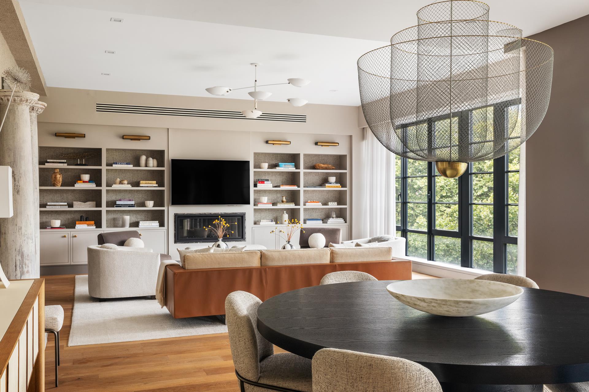 204 Forsyth Street, Unit PH6 Manhattan, NY 10002 - Photo 3 of 22 a living room with furniture a flat screen tv and a large window