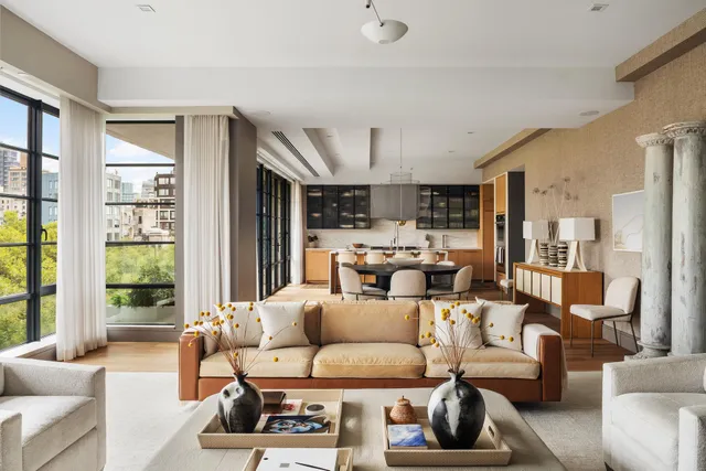 a living room with furniture a flat screen tv and a large window