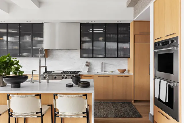 a dining room with furniture a chandelier and wooden floor
