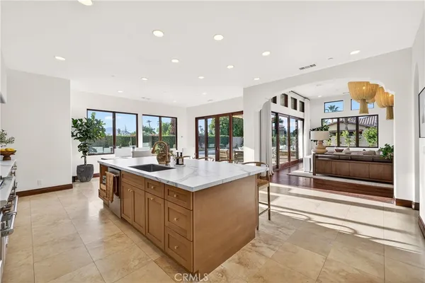 a large kitchen with kitchen island a sink and a stove
