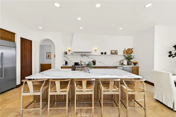 a large kitchen with a table and chairs