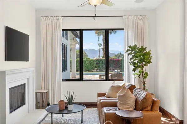a living room with furniture a window and a fireplace