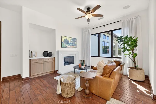 a living room with furniture a chandelier and a fireplace