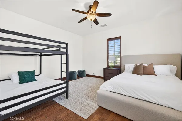 a bedroom with a bed a bed and a chandelier