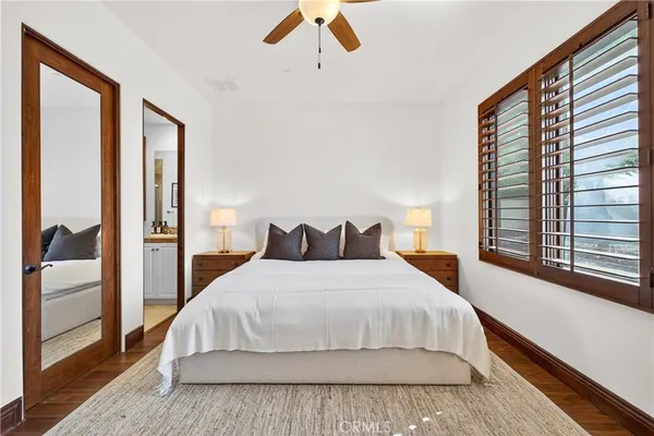 a bedroom with a large bed and a large window