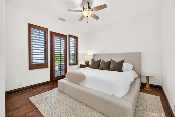 a spacious bedroom with a large bed and a chandelier