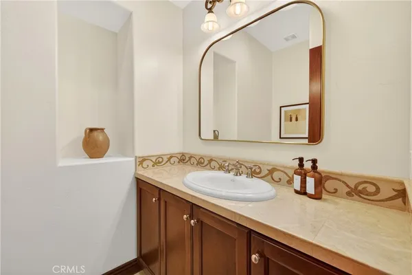 a bathroom with a sink vanity and mirror