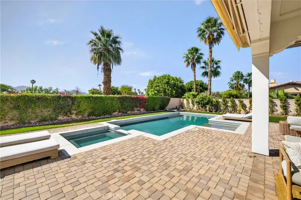 a view of swimming pool with a yard and potted plants