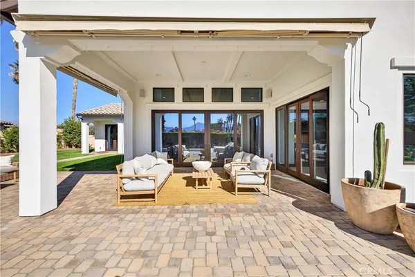 a view of a patio with couches chairs and potted plants