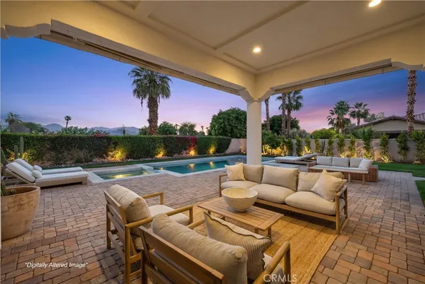 a patio with patio couch and a fire pit