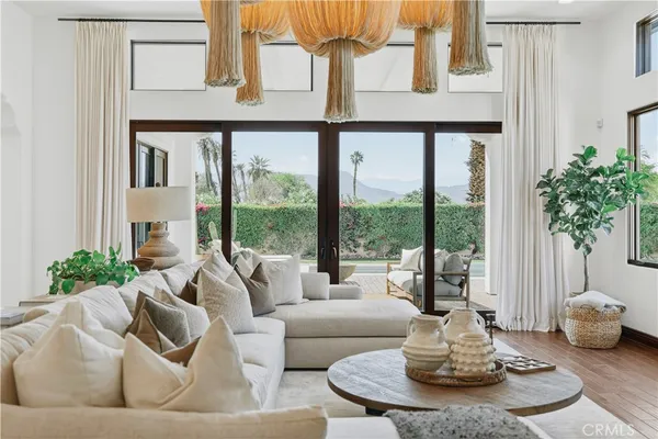 a living room with furniture and a potted plant