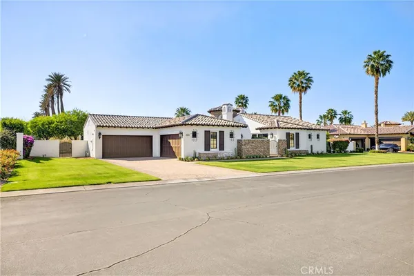 a front view of house with a garden and yard