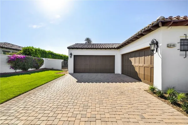 a front view of a house with a garden and yard
