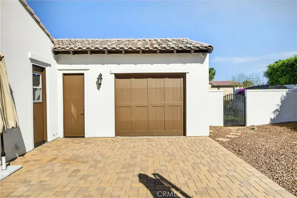 a view of a house with a wooden roof deck