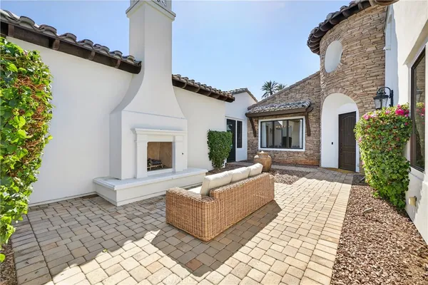 a view of a white house next to a yard