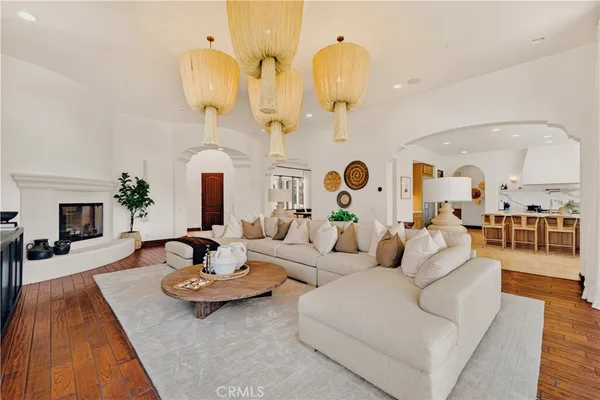 a living room with furniture kitchen view and a fireplace