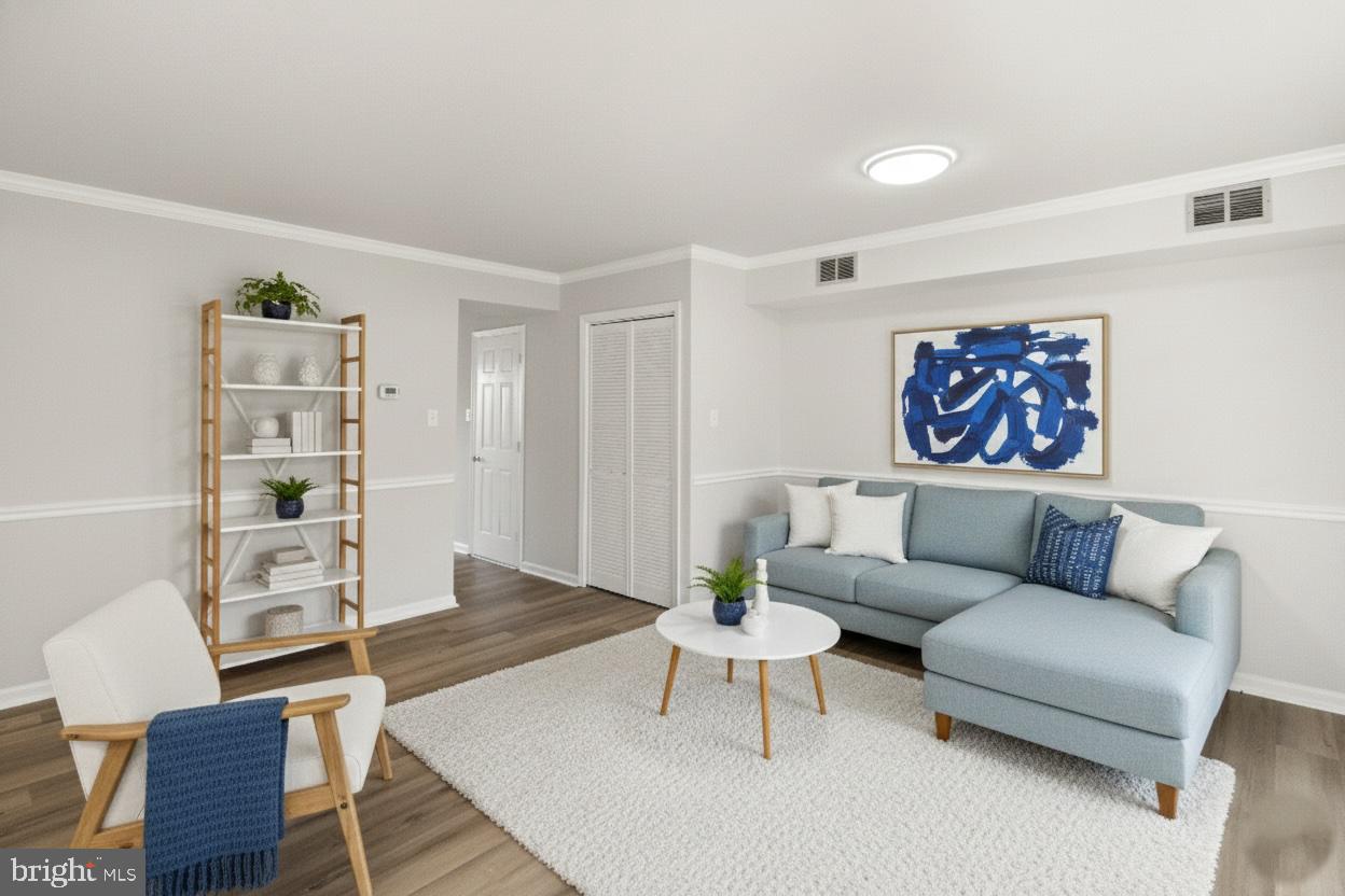 8519 Westover Court, Unit 763 Springfield, VA 22152 - Photo 11 of 36 a living room with furniture a rug and a wall painting