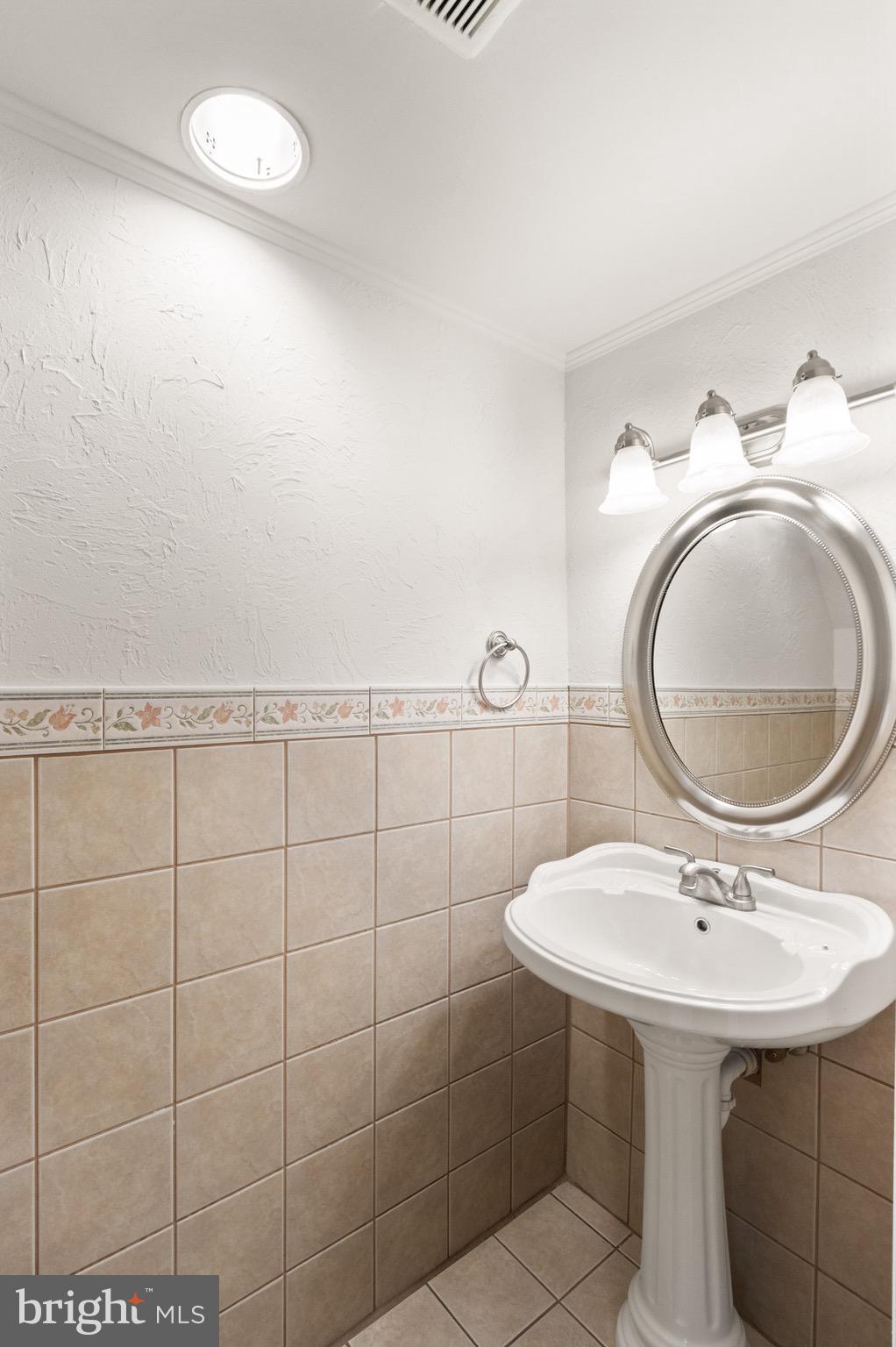 8519 Westover Court, Unit 763 Springfield, VA 22152 - Photo 14 of 36 a bathroom with a sink a mirror and a sink