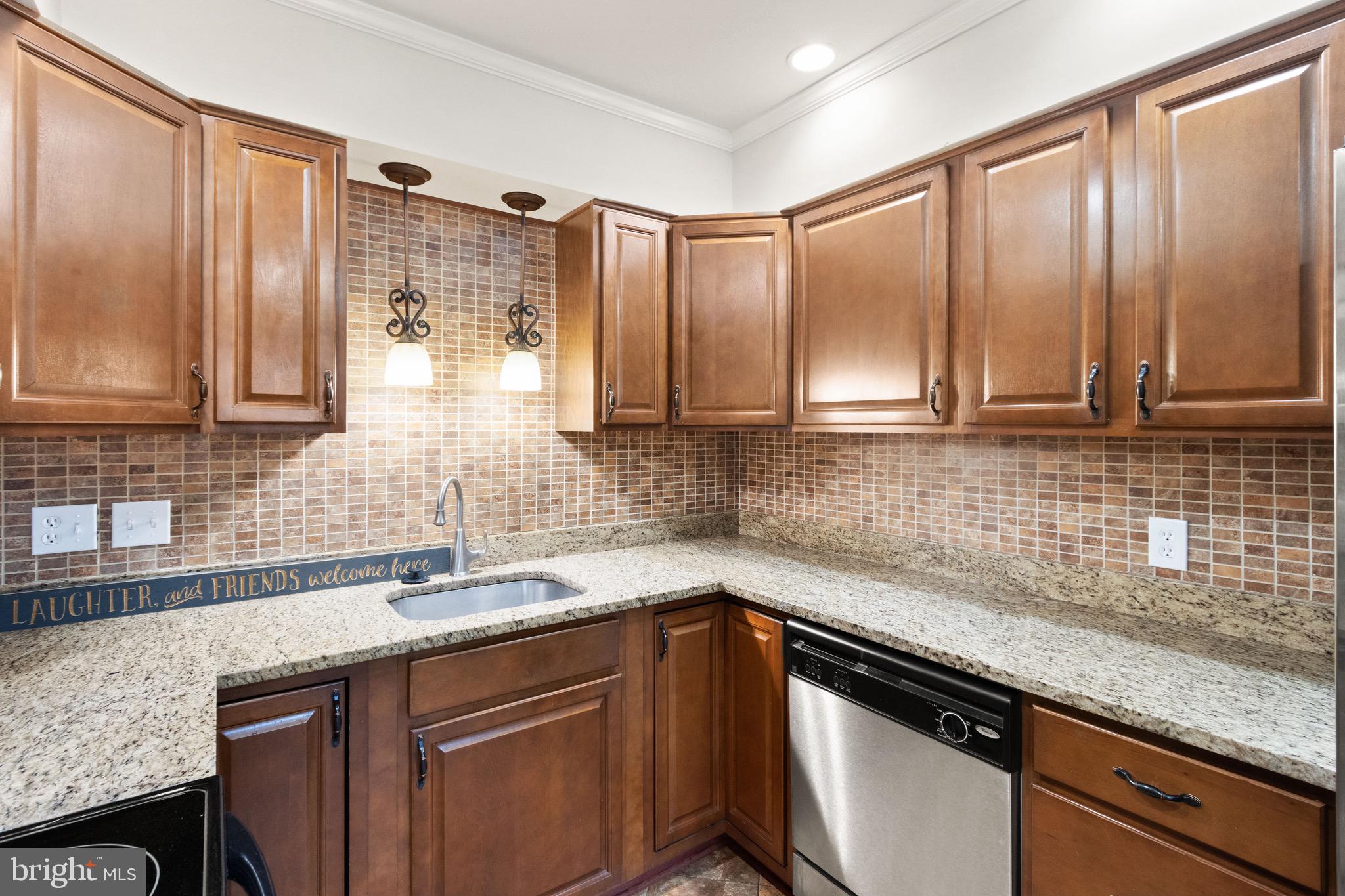 8519 Westover Court, Unit 763 Springfield, VA 22152 - Photo 34 of 36 a kitchen with stainless steel appliances granite countertop a sink a stove and cabinets