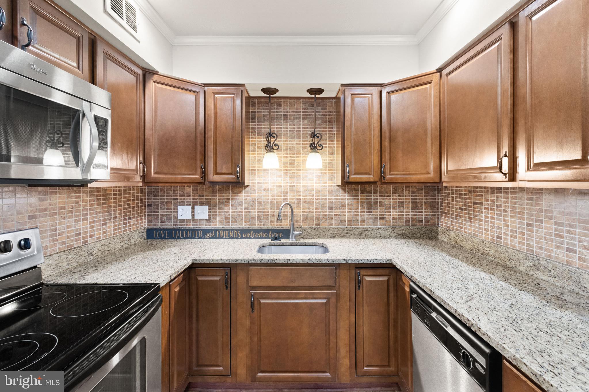 8519 Westover Court, Unit 763 Springfield, VA 22152 - Photo 35 of 36 a kitchen with stainless steel appliances granite countertop a sink stove and cabinets