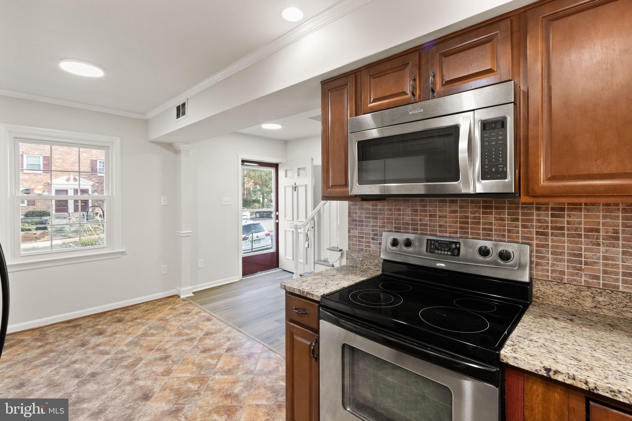 8519 Westover Court, Unit 763 Springfield, VA 22152 - Photo 36 of 36 a kitchen with granite countertop cabinets stove and microwave