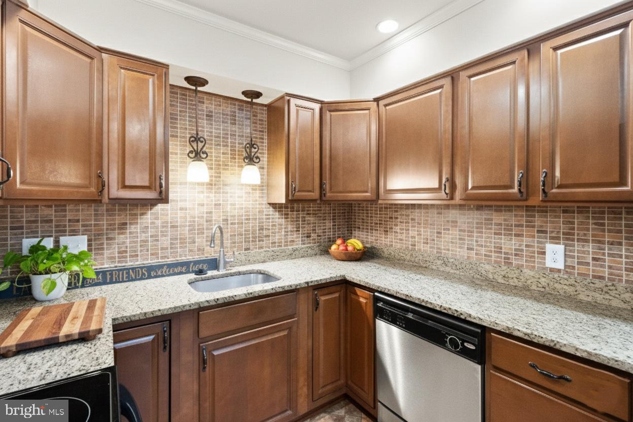 8519 Westover Court, Unit 763 Springfield, VA 22152 - Photo 5 of 36 a kitchen with stainless steel appliances granite countertop a sink a stove and cabinets