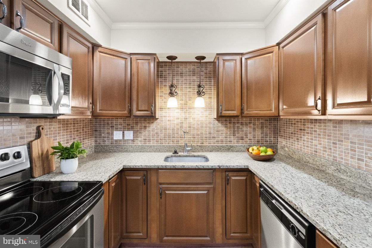 8519 Westover Court, Unit 763 Springfield, VA 22152 - Photo 6 of 36 a kitchen with stainless steel appliances granite countertop a sink stove and cabinets