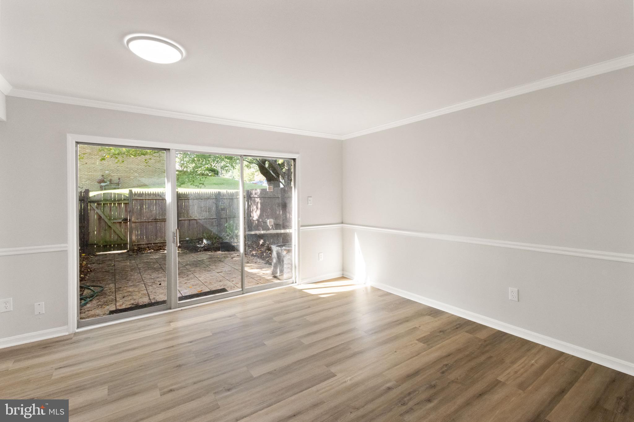 8519 Westover Court, Unit 763 Springfield, VA 22152 - Photo 9 of 36 an empty room with wooden floor and windows