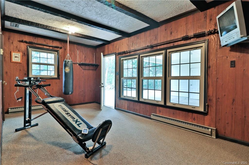 3532 Mountainbrook Road Charlotte, NC 28226 - Photo 13 of 45 a living room with furniture gym equipment and a large window