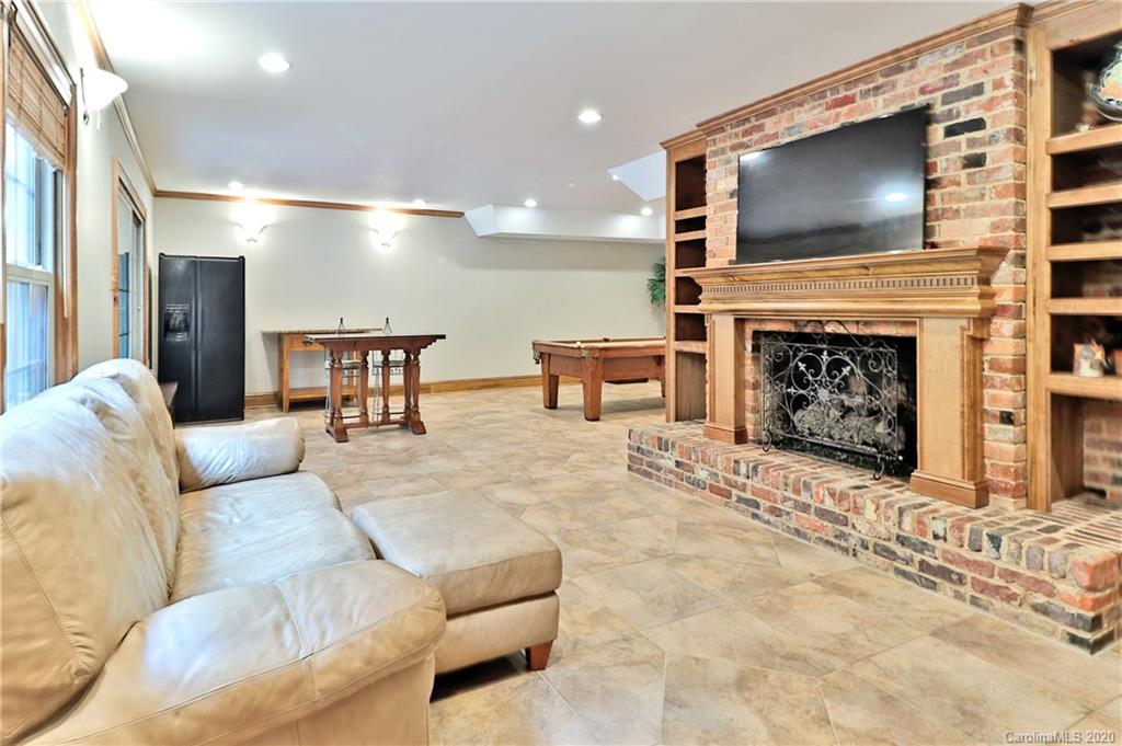 3532 Mountainbrook Road Charlotte, NC 28226 - Photo 20 of 45 a living room with furniture a fireplace and a flat screen tv