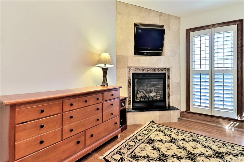 3532 Mountainbrook Road Charlotte, NC 28226 - Photo 40 of 45 a living room with furniture a fireplace and a flat screen tv