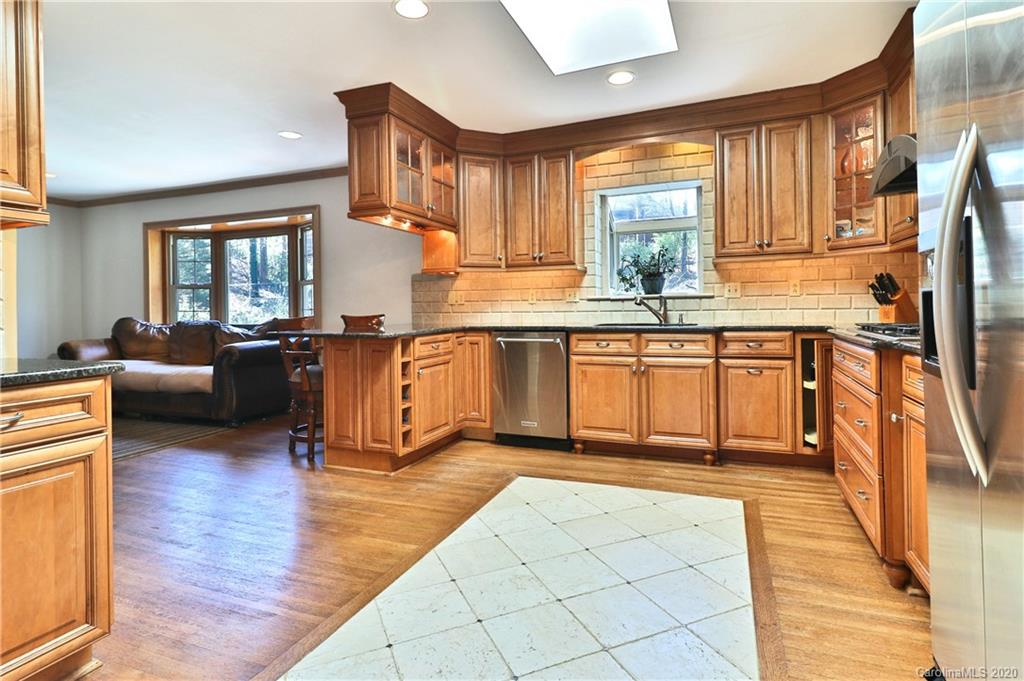 3532 Mountainbrook Road Charlotte, NC 28226 - Photo 8 of 45 a kitchen with stainless steel appliances granite countertop a stove top oven a sink dishwasher and cabinets with wooden floor
