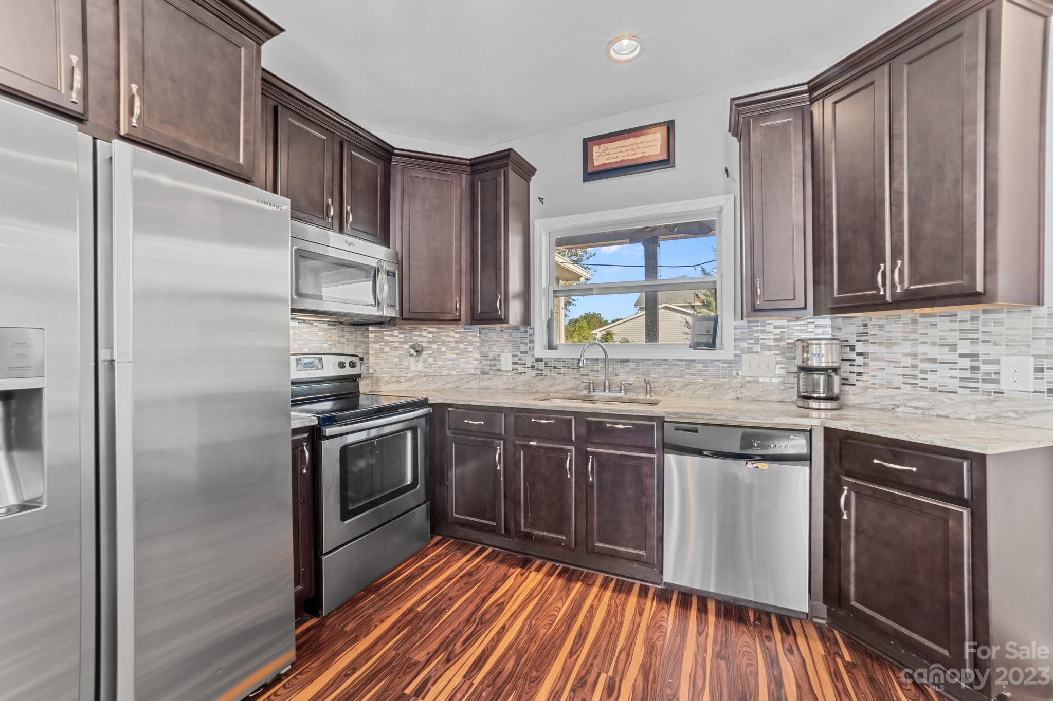 105 Vista Drive Davidson, NC 28036 - Photo 12 of 29 a kitchen with stainless steel appliances granite countertop a stove a sink and a refrigerator