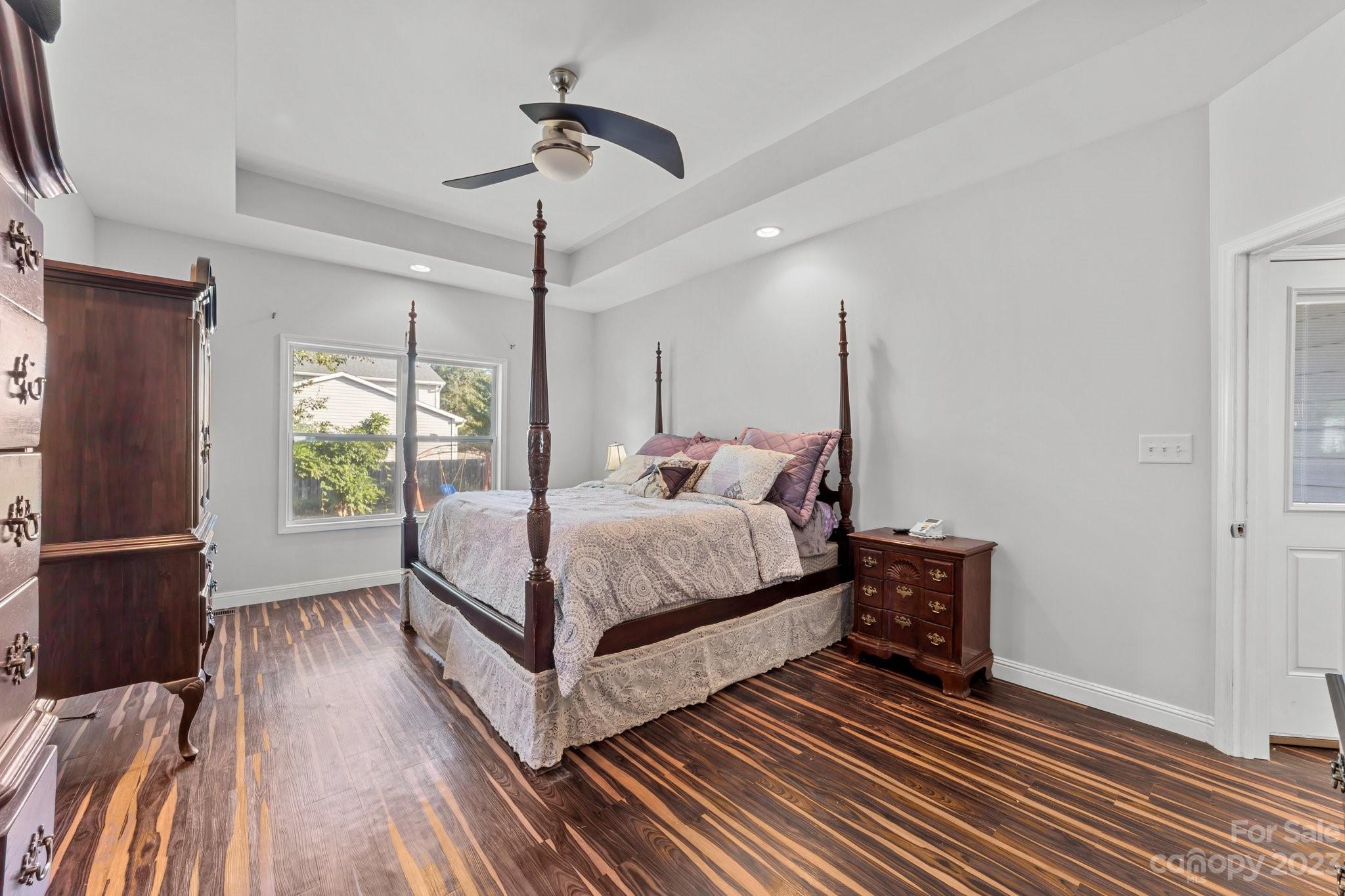 105 Vista Drive Davidson, NC 28036 - Photo 17 of 29 a bedroom with a bed lamp closet and large window