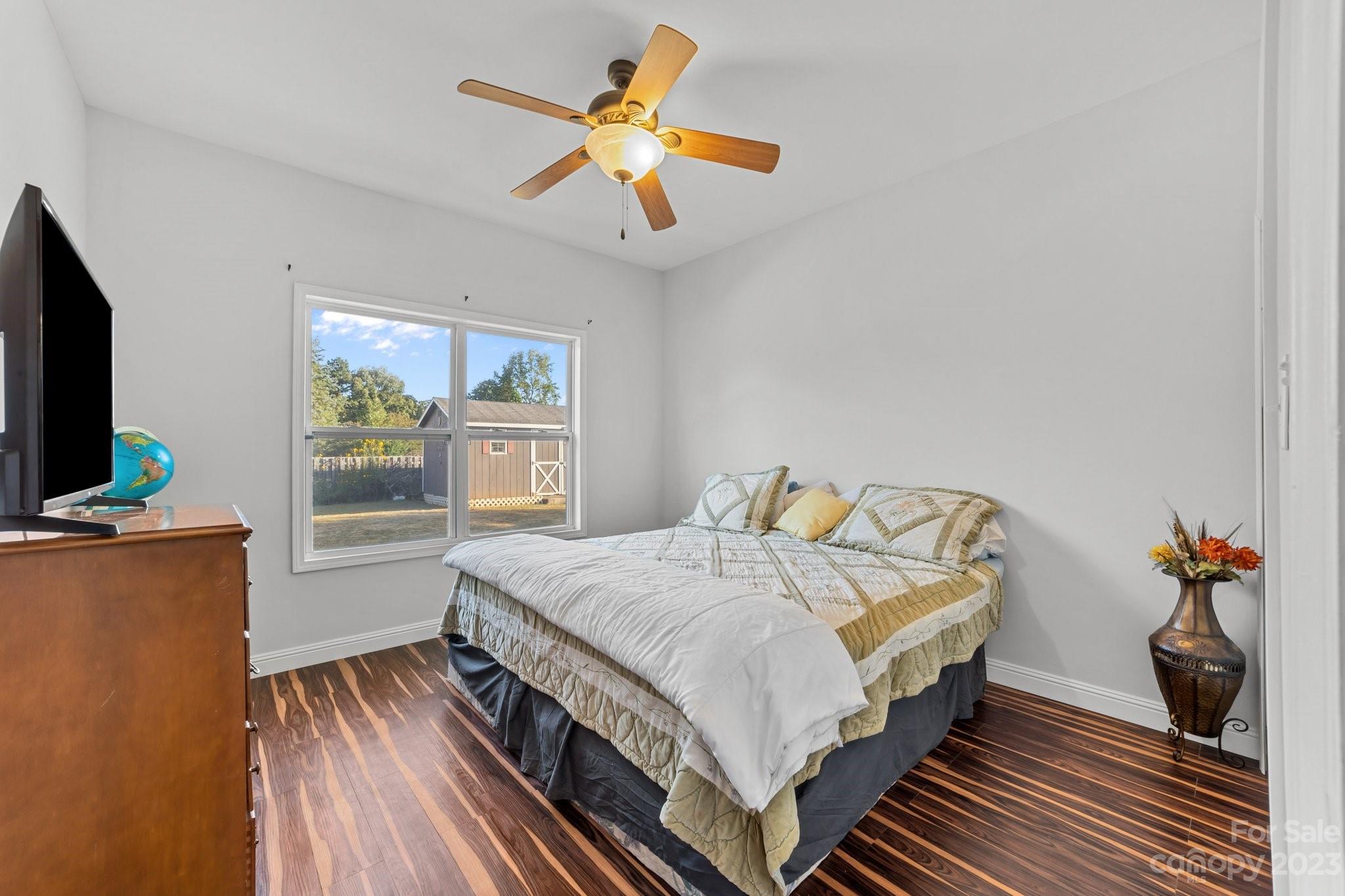 105 Vista Drive Davidson, NC 28036 - Photo 21 of 29 a bedroom with a bed and a flat tv screen on dresser