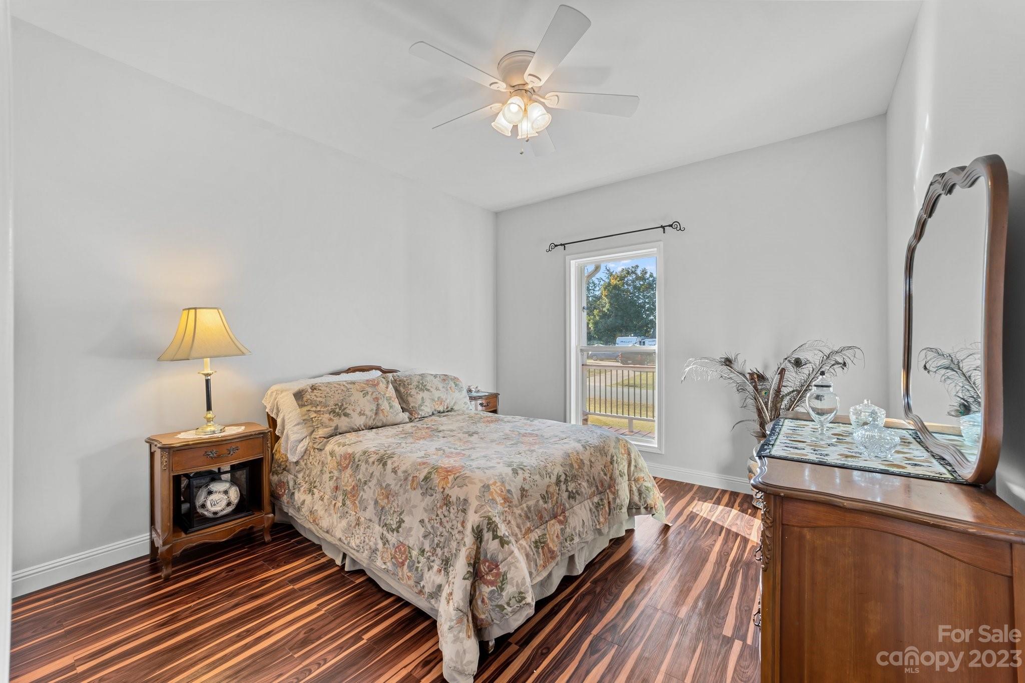 105 Vista Drive Davidson, NC 28036 - Photo 22 of 29 a bedroom with a bed chandelier and a window