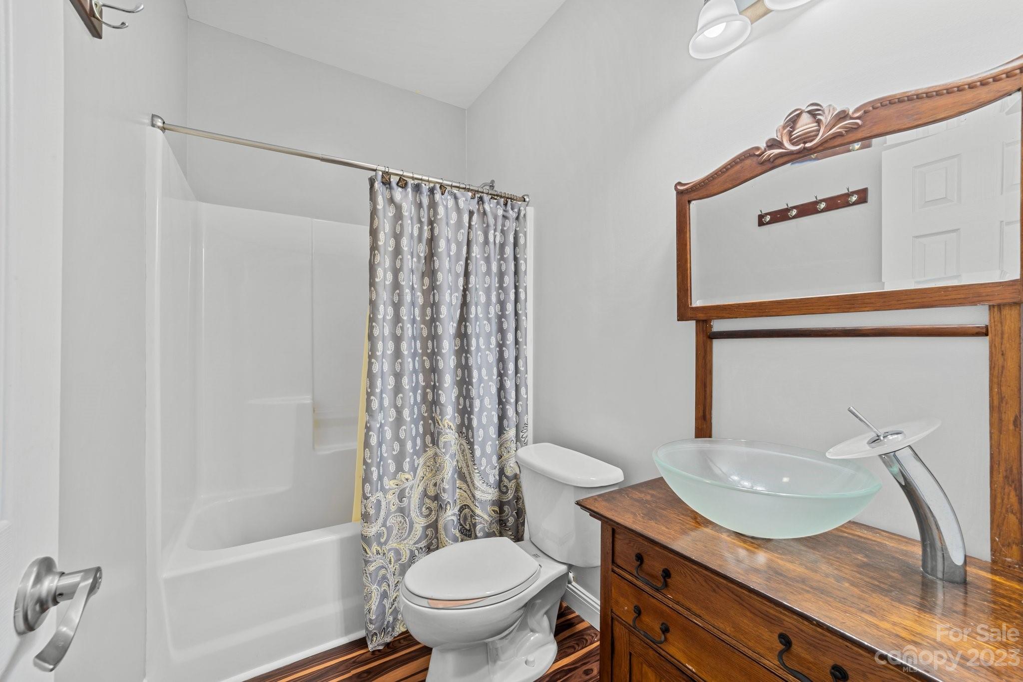 105 Vista Drive Davidson, NC 28036 - Photo 23 of 29 a bathroom with a granite countertop sink toilet and shower