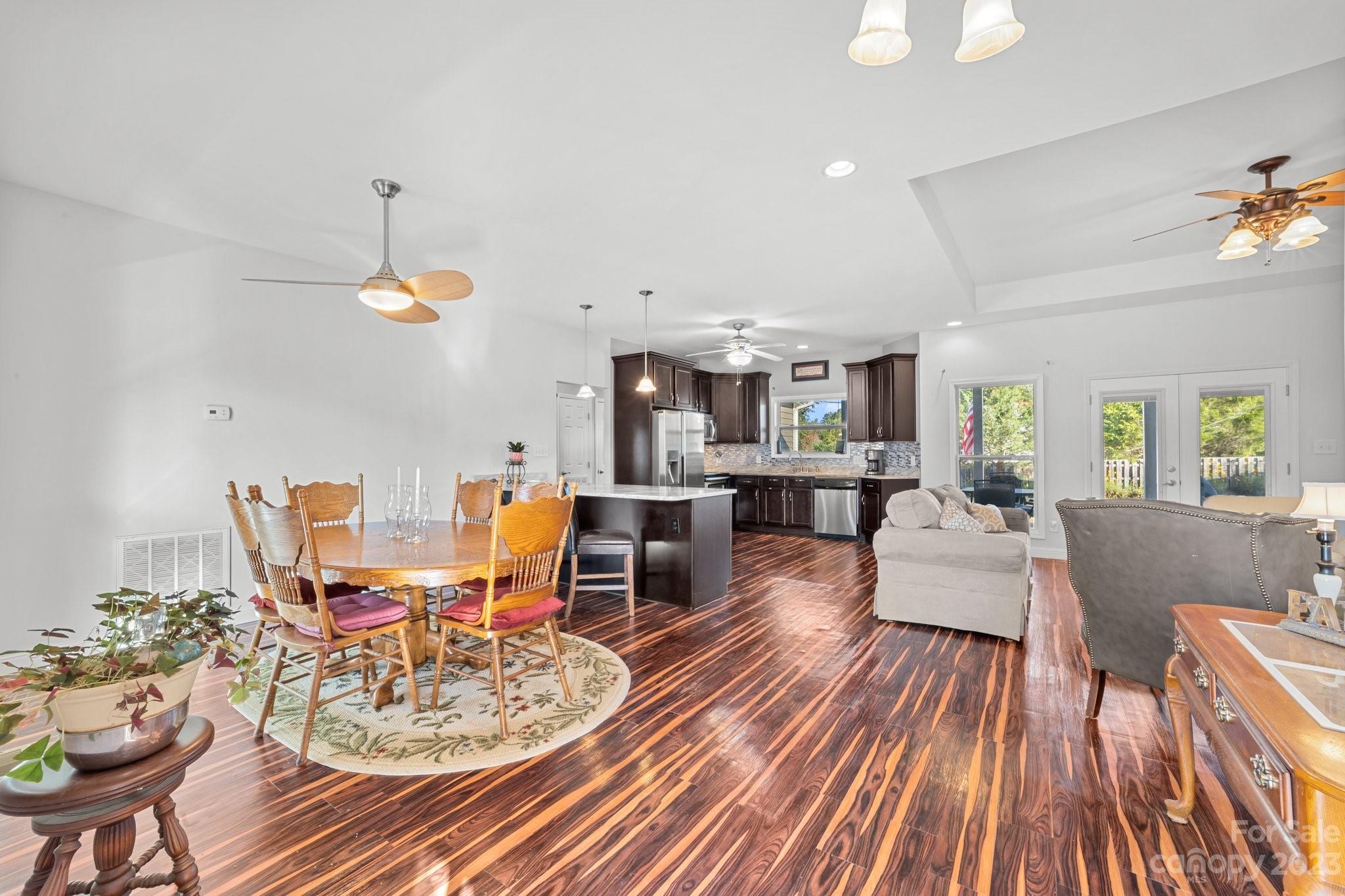 105 Vista Drive Davidson, NC 28036 - Photo 7 of 29 a dining room with wooden floor a chandelier a glass table and chairs