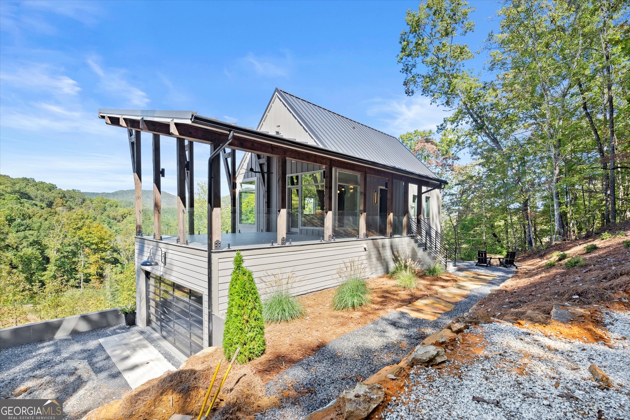 a view of a house with a porch next to a yard