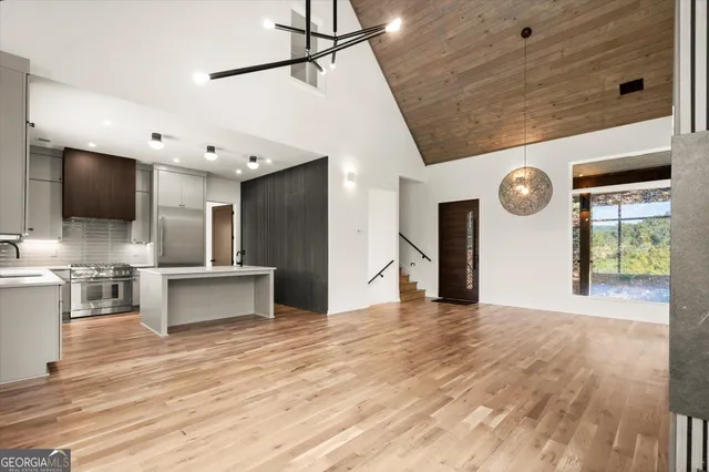a view of an empty room with glass door and a window