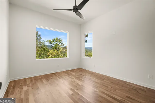 a view of a lush green hillside and houses