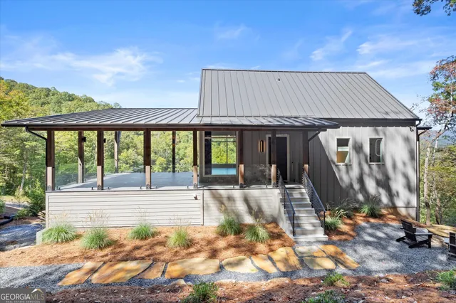 a backyard of a house with outdoor seating