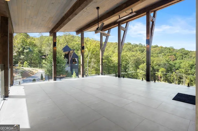 a view of a hallway with wooden floor and chandelier