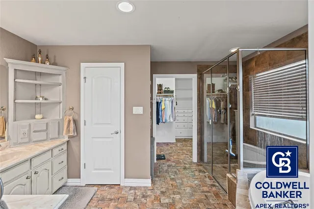 a bathroom with a shower and a sink
