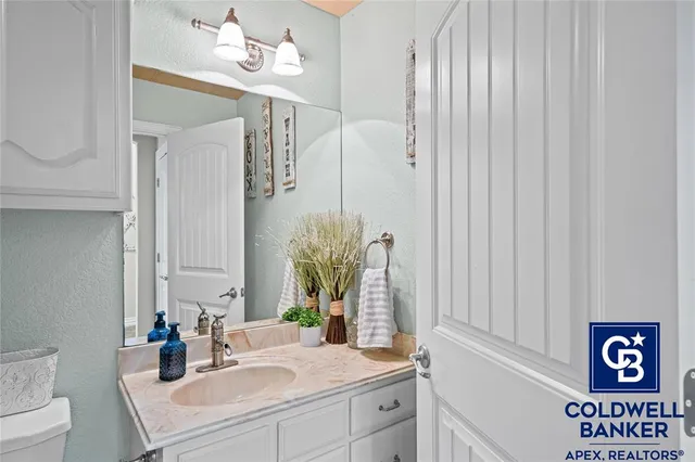 a bathroom with a sink a mirror and a toilet