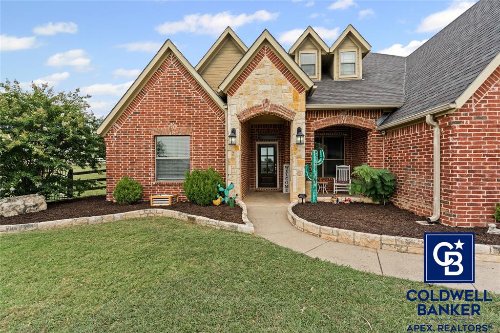 1316 Prairie Point Rhome, TX 76078 - Photo 2 of 30 a front view of a house with garden