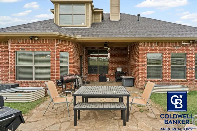 a view of a patio with table and chairs and wooden floor